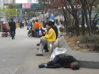Homeless man sleeping on the pavement